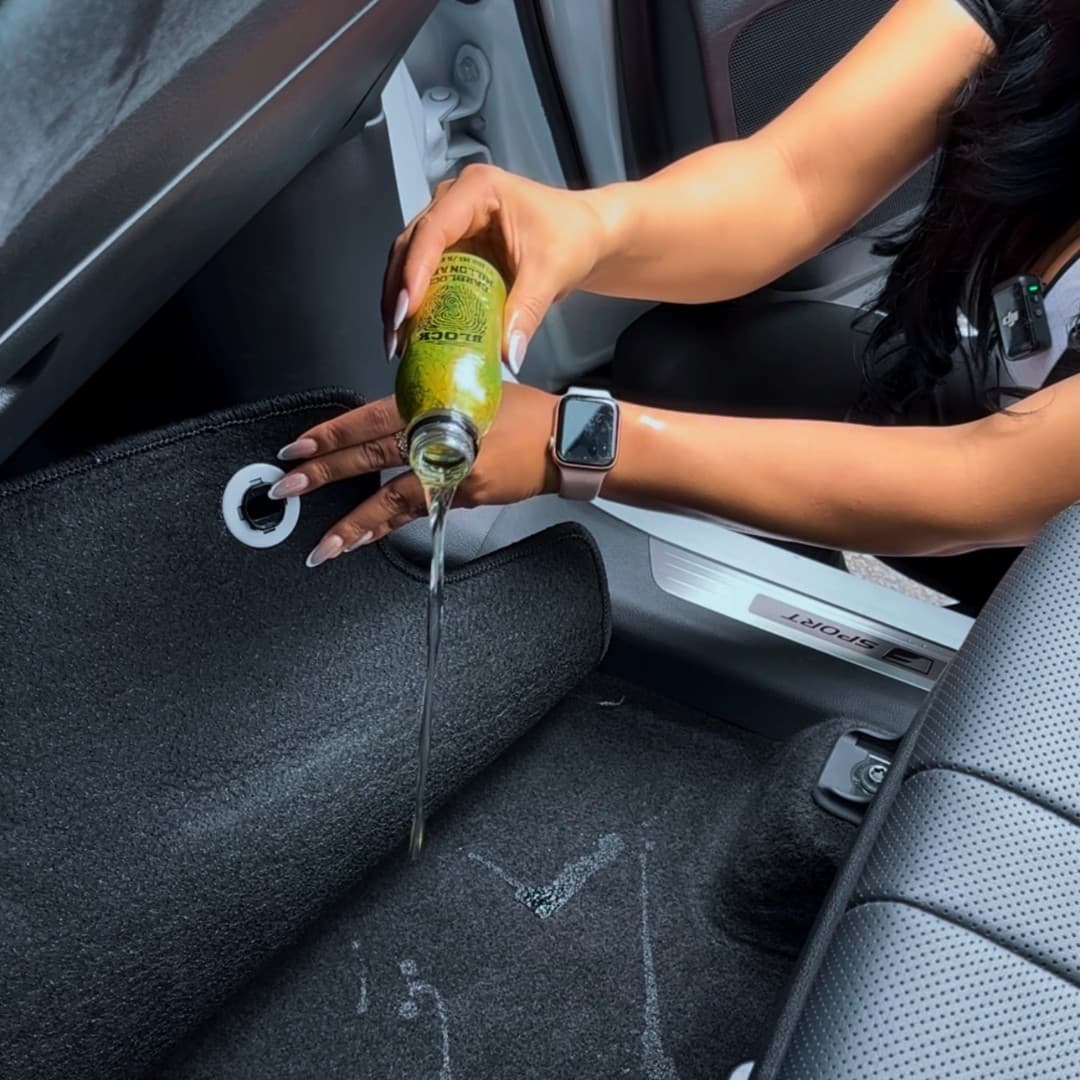 Lift the mat. Pour underneath. Replace.